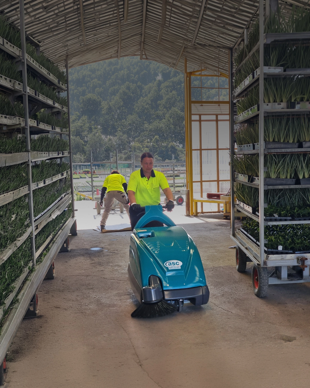Industrial sweeper cleaning agricultural storage facility floor in Queensland