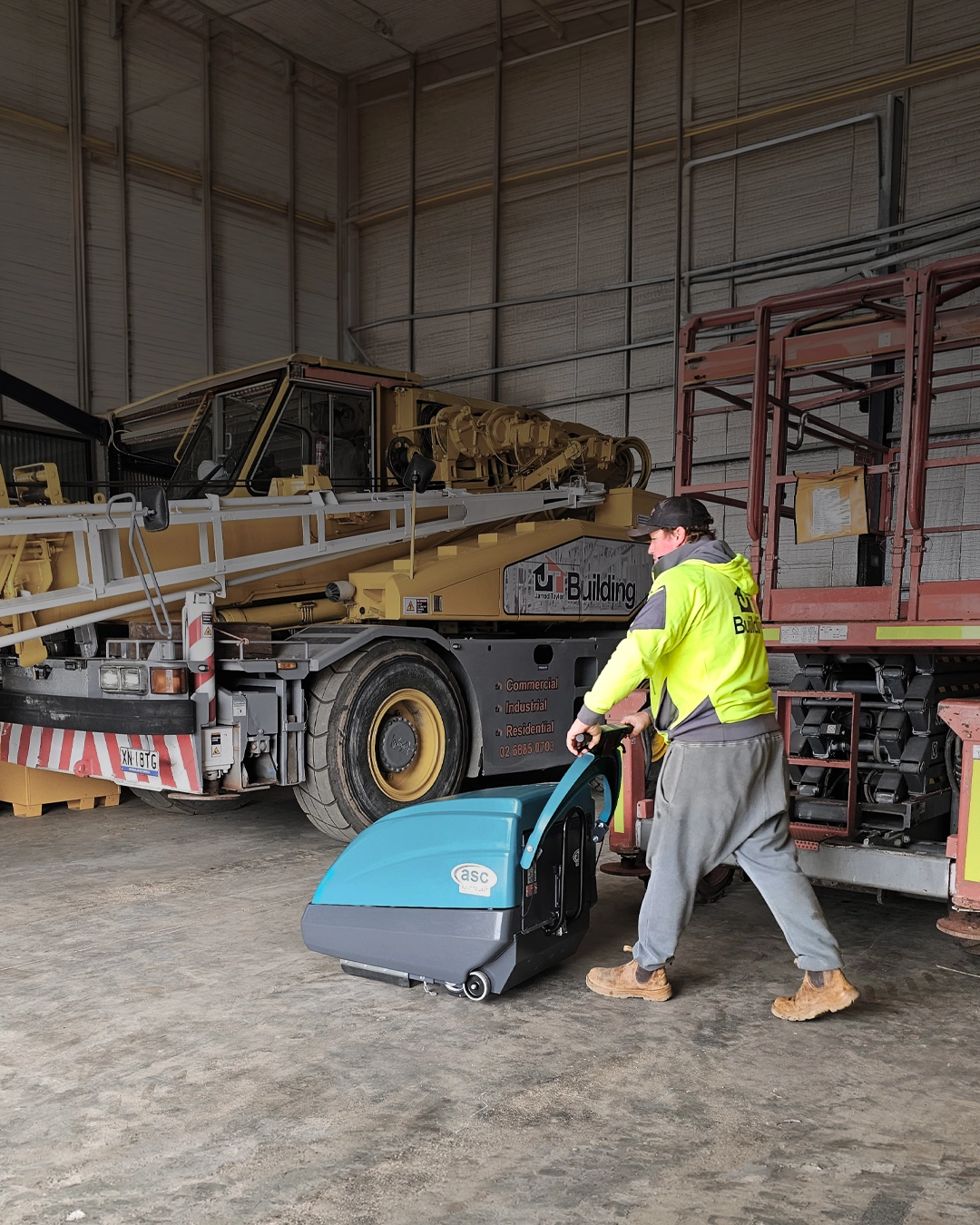 Walk-behind industrial sweeper cleaning construction equipment workshop