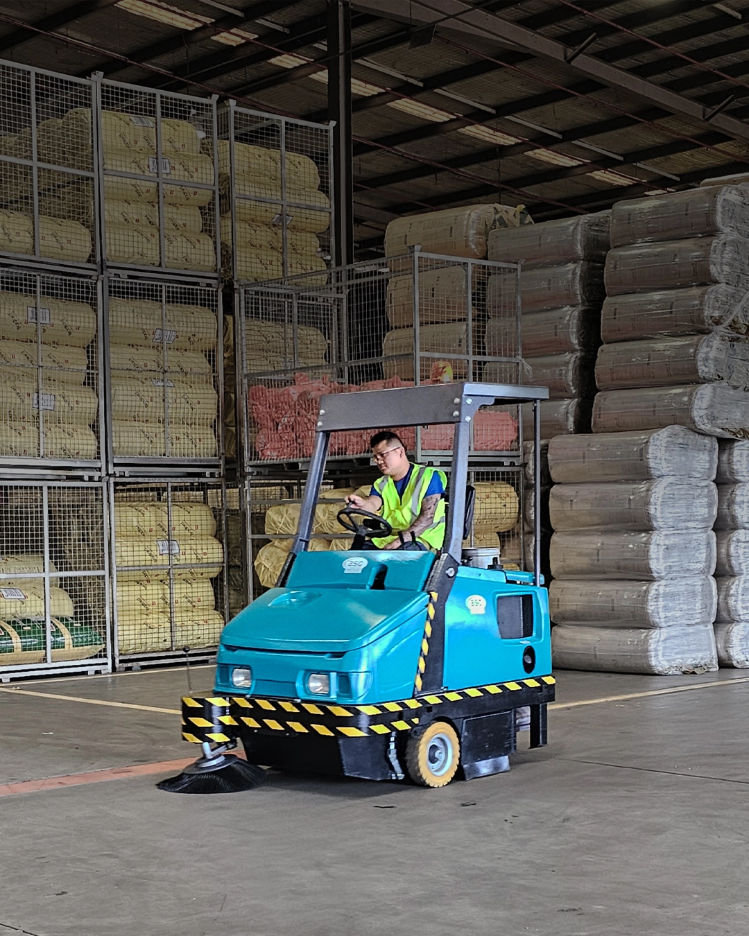 Industrial sweeper cleaning freight storage and shipping facility