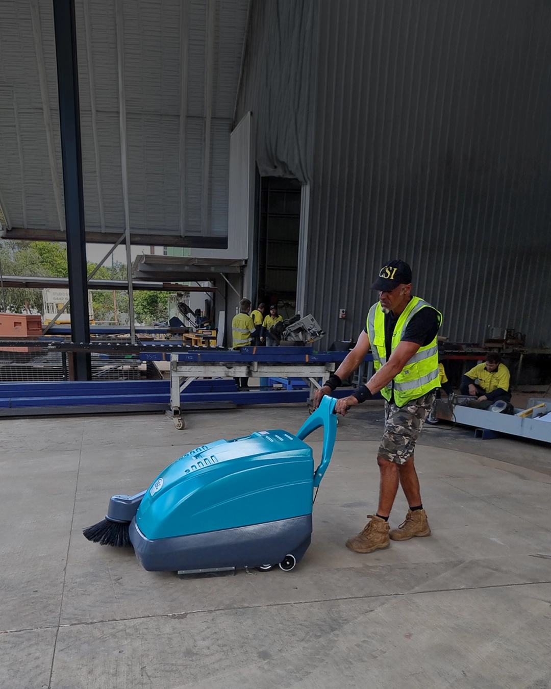 Industrial sweeper controlling dust at mining processing facility