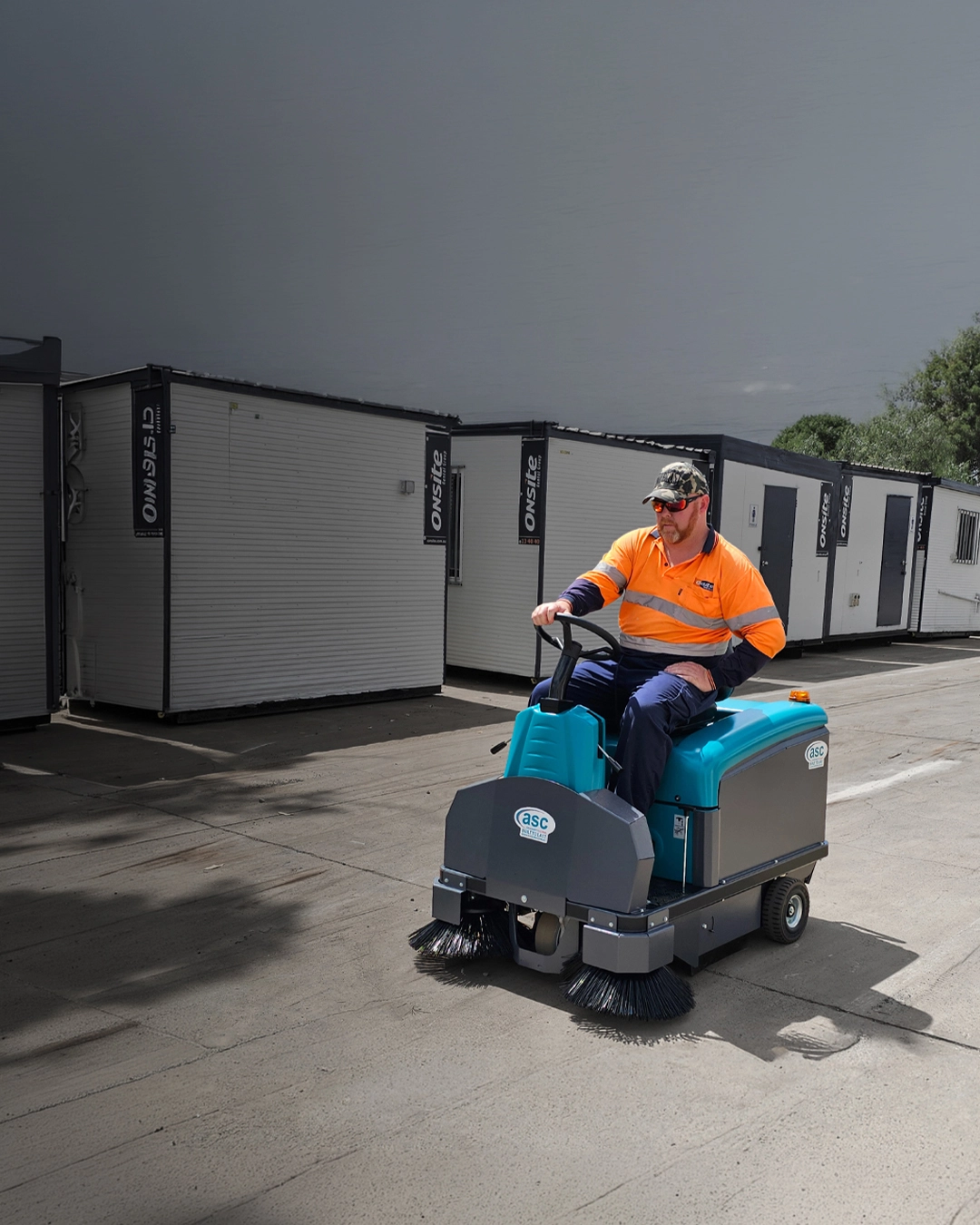 Ride-on sweeper cleaning commercial car park and outdoor hard surfaces